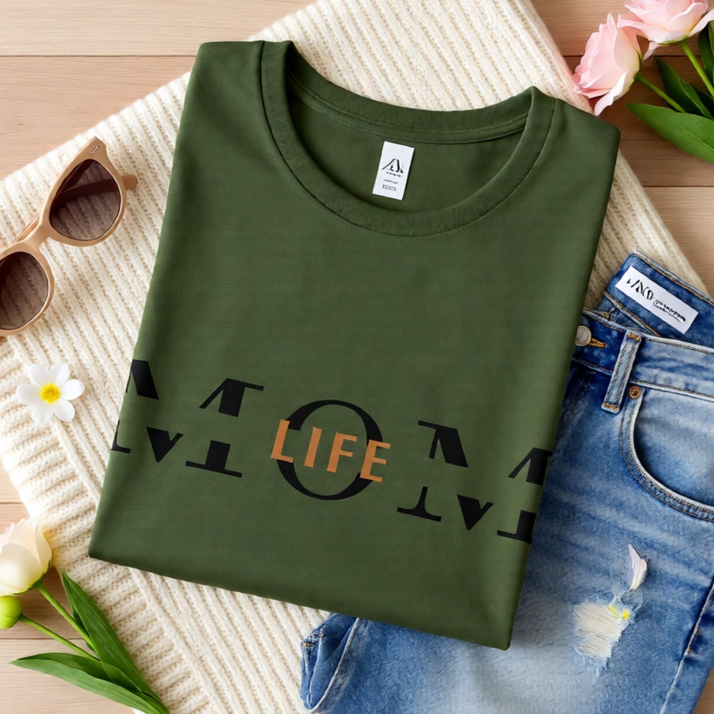 Military green Bella Canvas t-shirt featuring the Mom Life design displayed in a styled flat lay mockup.