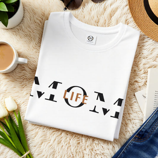Folded white Bella Canvas 3001 t-shirt featuring minimalist Mom Life graphic styled in a cozy flat lay setting.