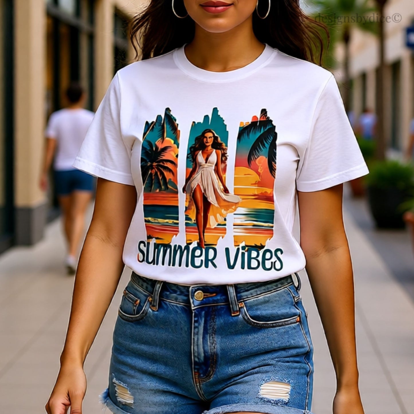 Person wearing a white t-shirt with a 'Summer Vibes' design on a city street.