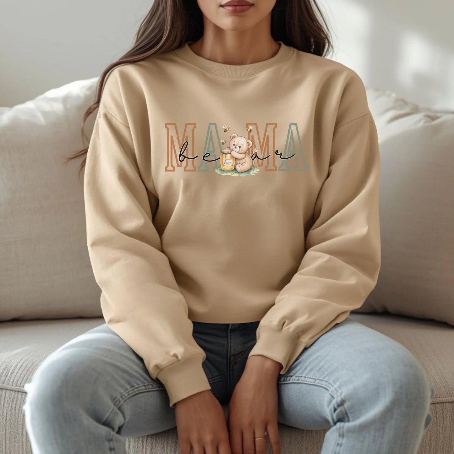 Relaxed lifestyle image of a beige Gildan crewneck sweatshirt with the Mama role design, showcasing a soft neutral tone and cozy everyday fit.