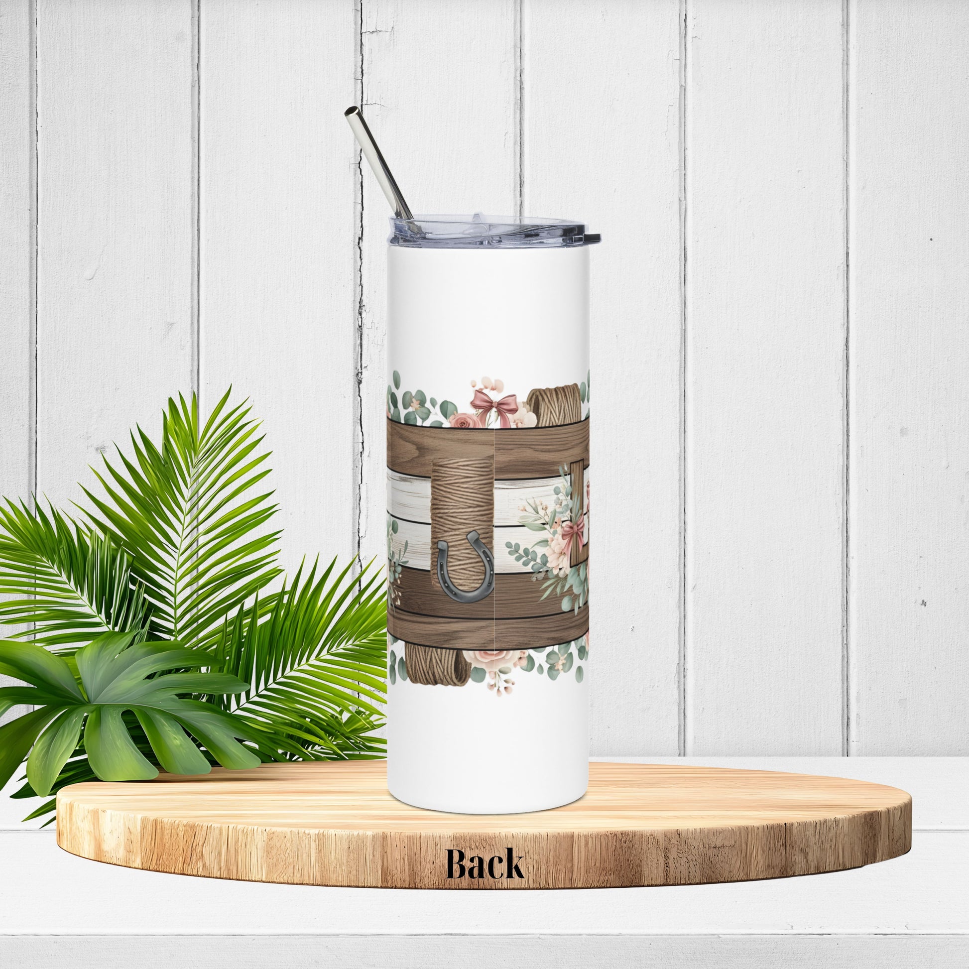 Tumbler wrap back view showing barn wood planks, twine spool and horseshoe accent surrounded by soft greenery.