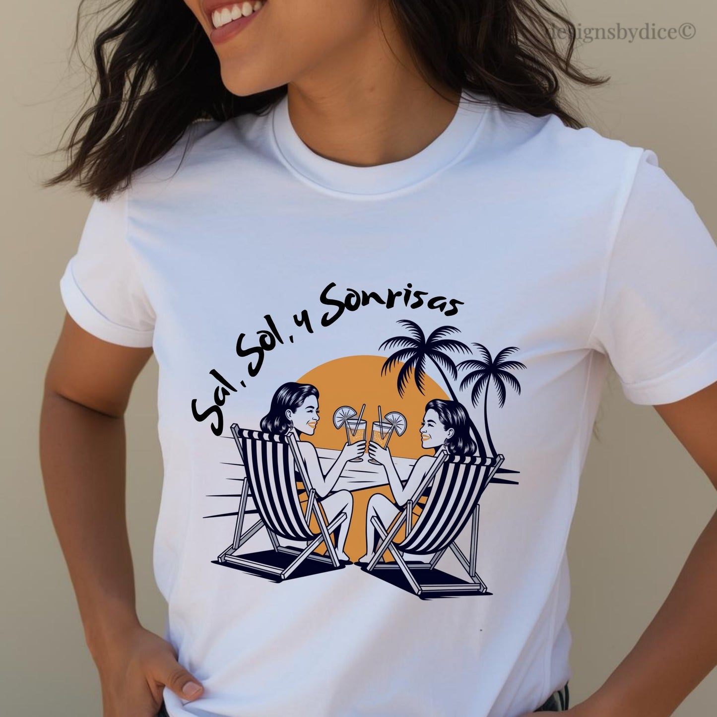 White t-shirt with a graphic design of two people in deck chairs and palm trees, worn by a person.