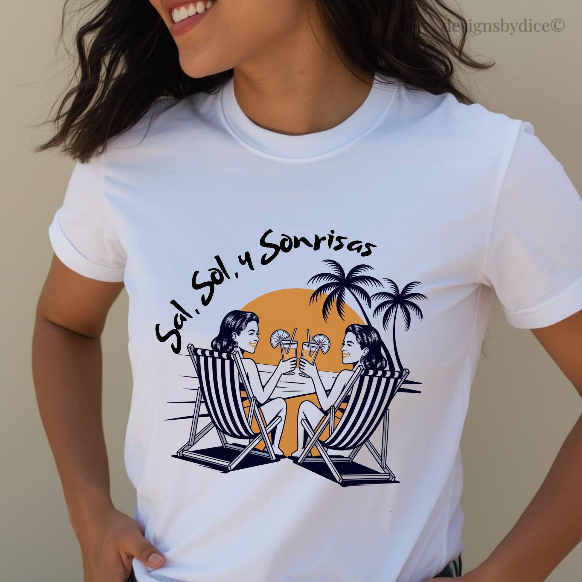 White t-shirt with a graphic design of two people in deck chairs and palm trees, worn by a person.