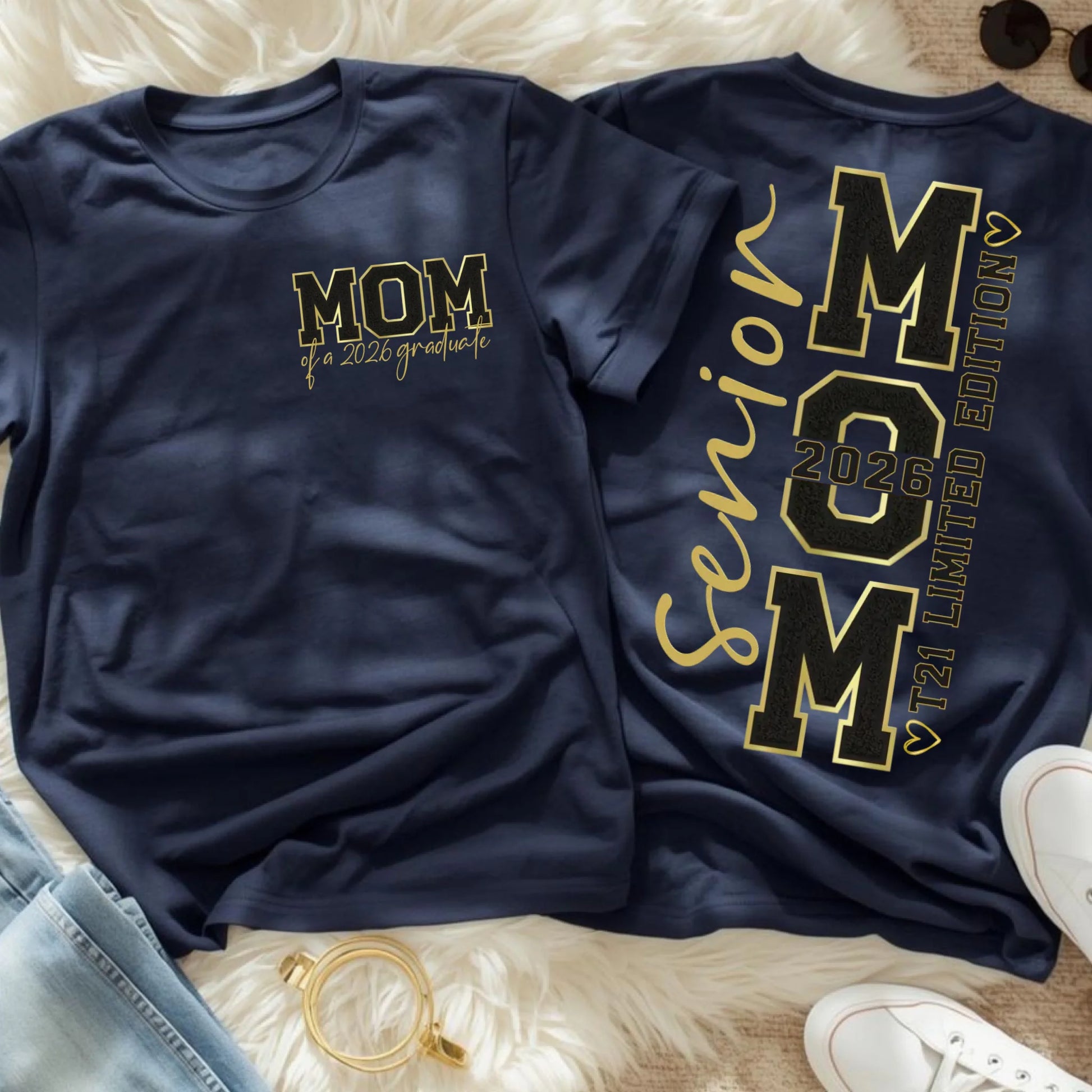 Navy Senior Mom 2026 shirt flat lay featuring front MOM of a 2026 graduate design and back senior mom T21 limited edition print