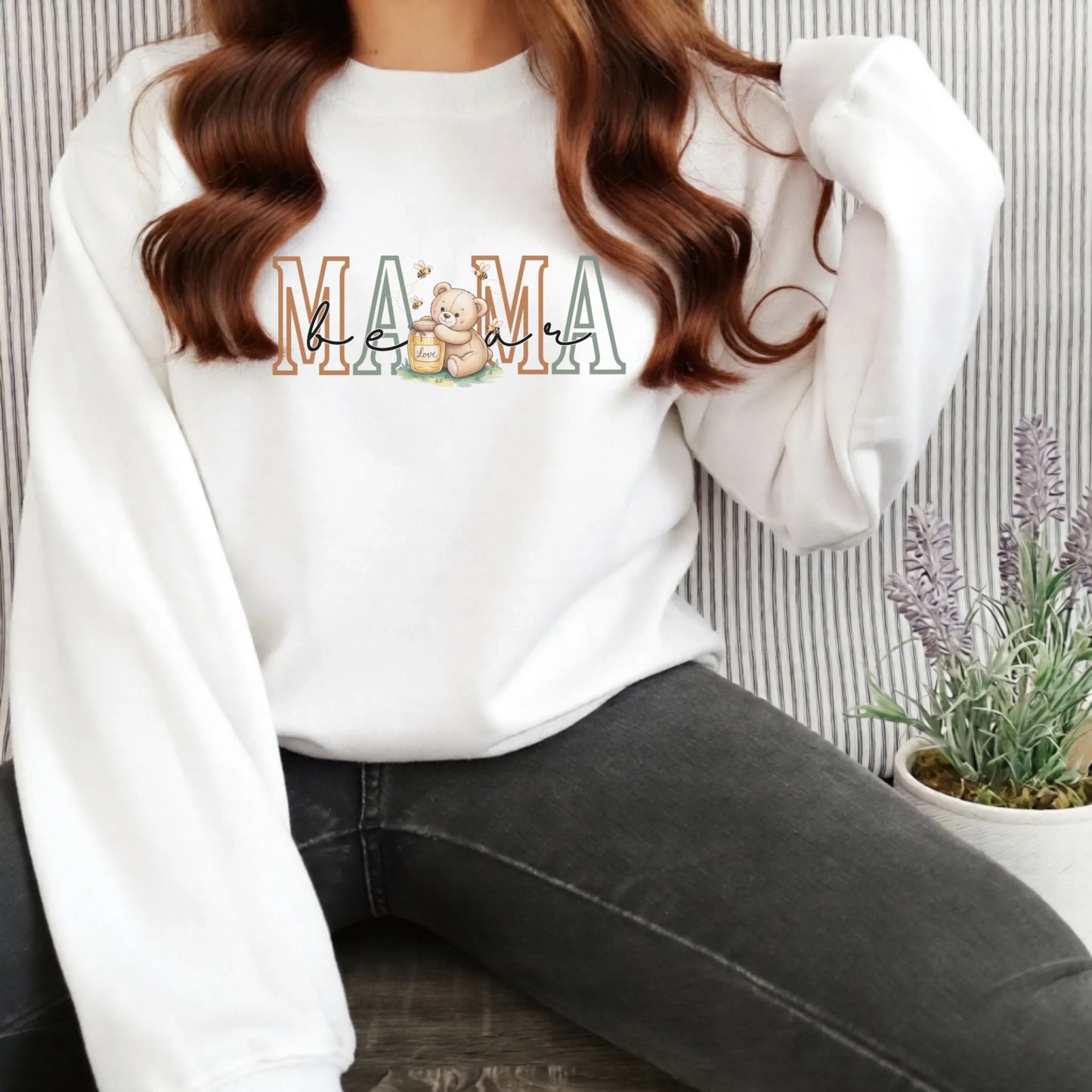 White Gildan crewneck sweatshirt featuring the Mama family role design with a teddy bear illustration, styled for a bright and classic look.