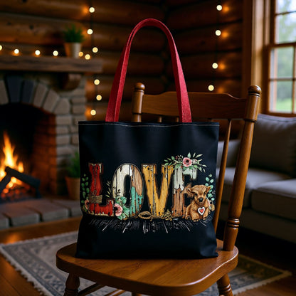 Black tote bag with 'LOVE' design on a wooden chair in a cozy room with a fireplace.