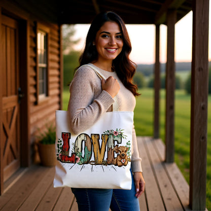 Woman holding a tote bag with 'LOVE' design on a wooden deck