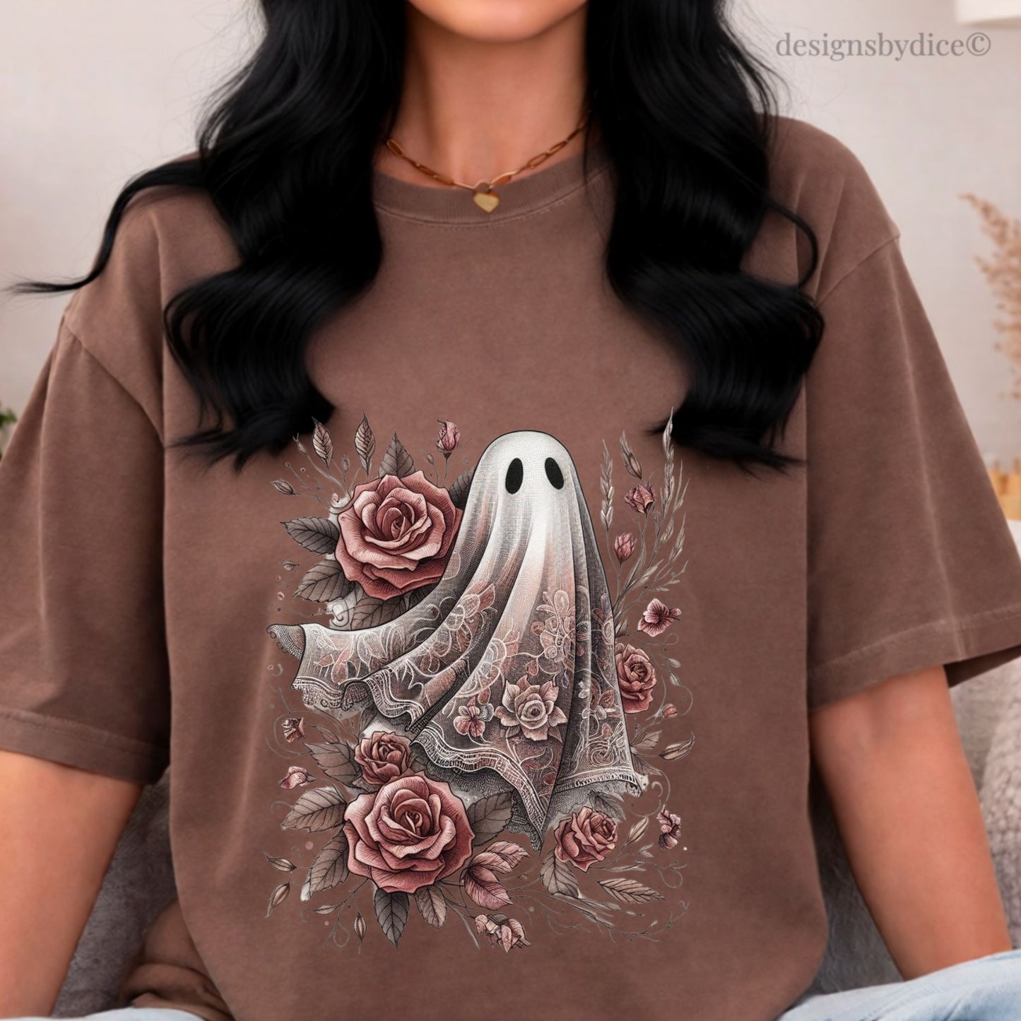 Person wearing a brown t-shirt with a ghost and floral design.