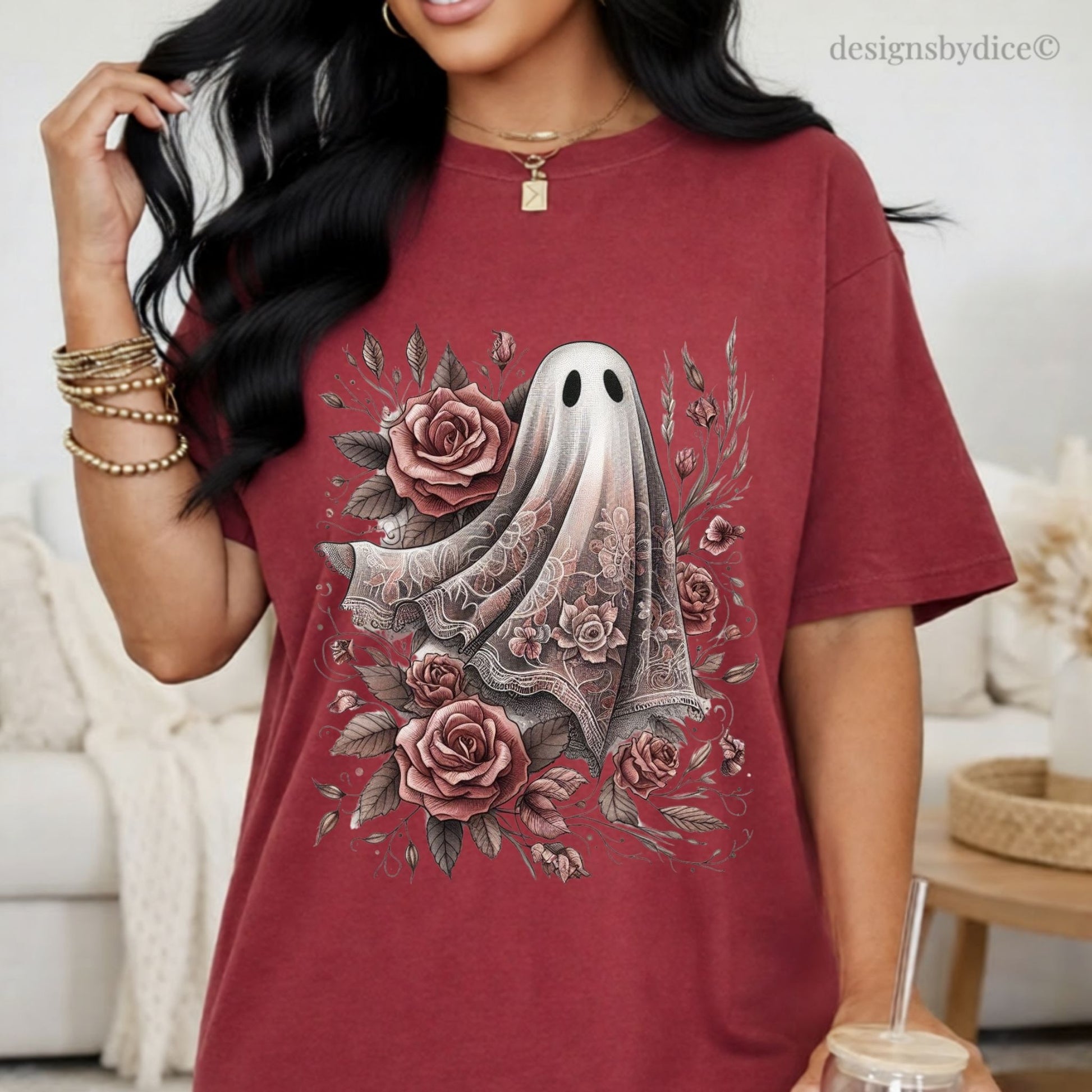 Person wearing a maroon t-shirt with a ghost and floral design, standing in a living room.
