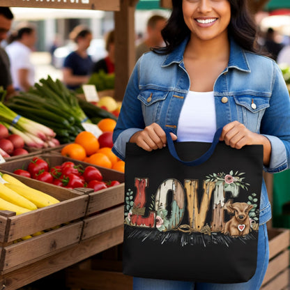 Woman holding a tote bag with 'LOVE' and animal illustrations at an outdoor market.