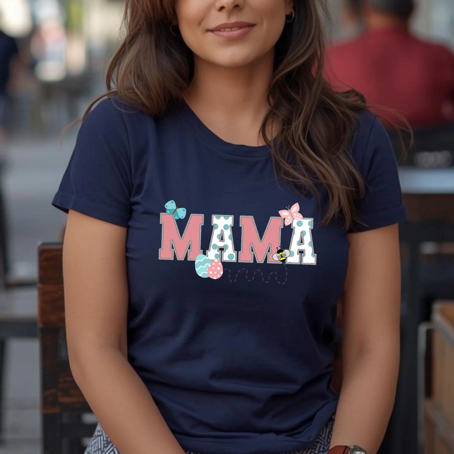 Woman wearing a navy Bella Canvas “Mama” Easter t-shirt from a Mommy and Me matching set, casual spring lifestyle photo.