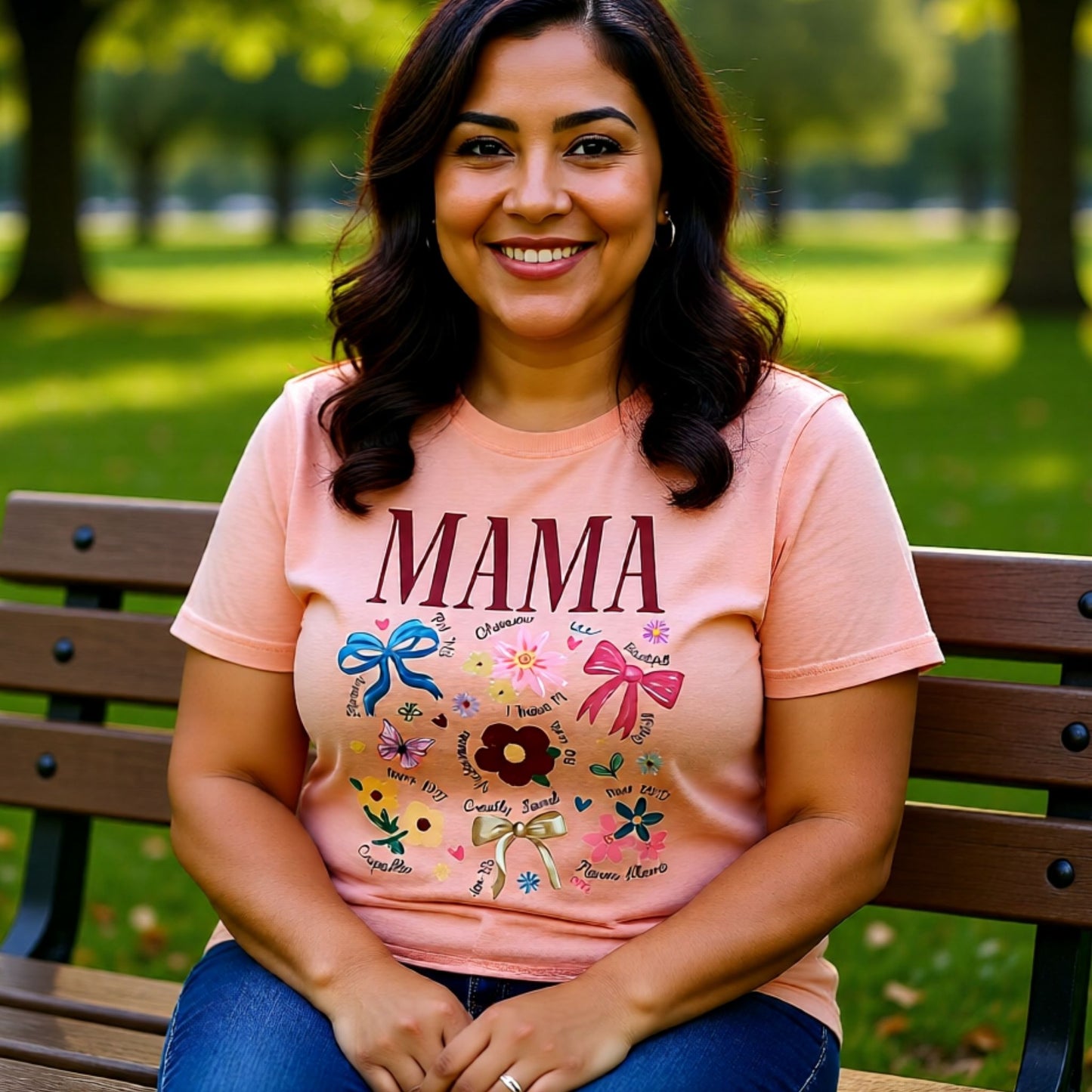 Smiling model wearing a soft peach Mama floral Bella Canvas t-shirt featuring heartfelt words and floral artwork for moms.