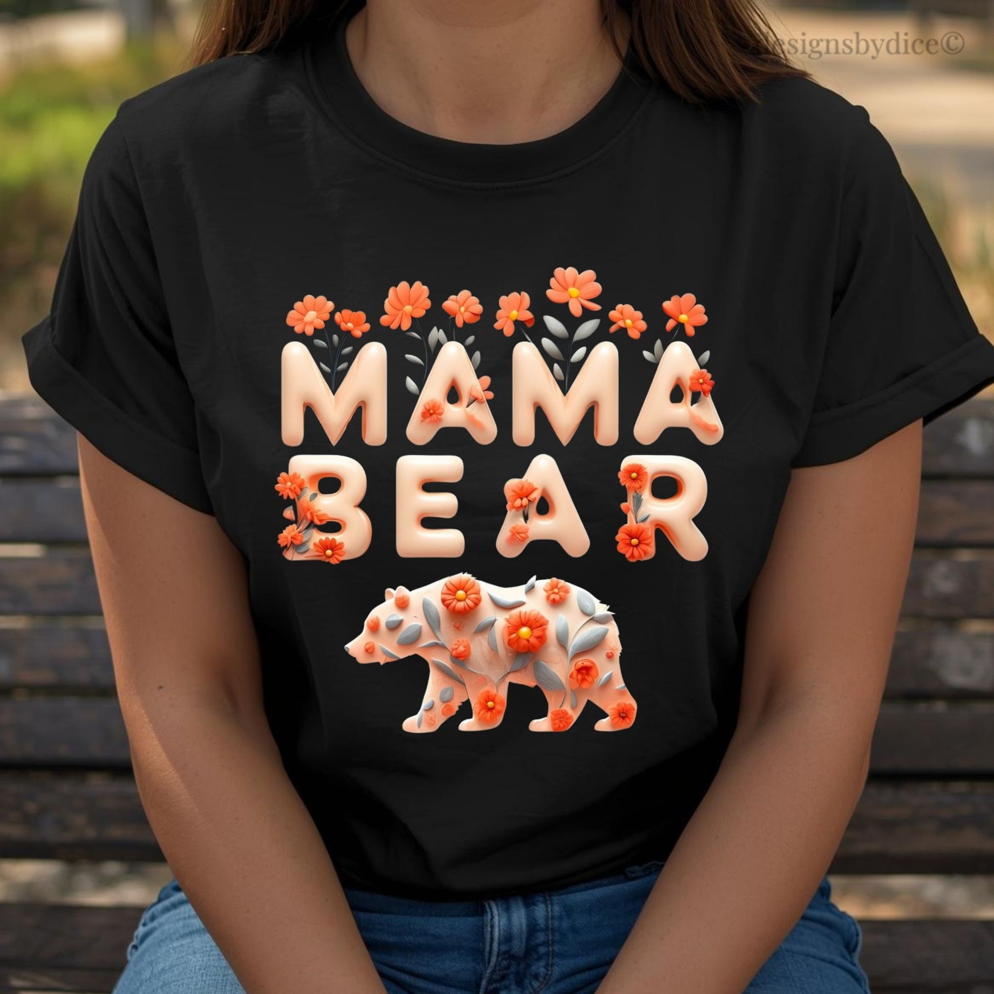 Black t-shirt with 'Mama Bear' design featuring a bear and flowers, worn by a person.