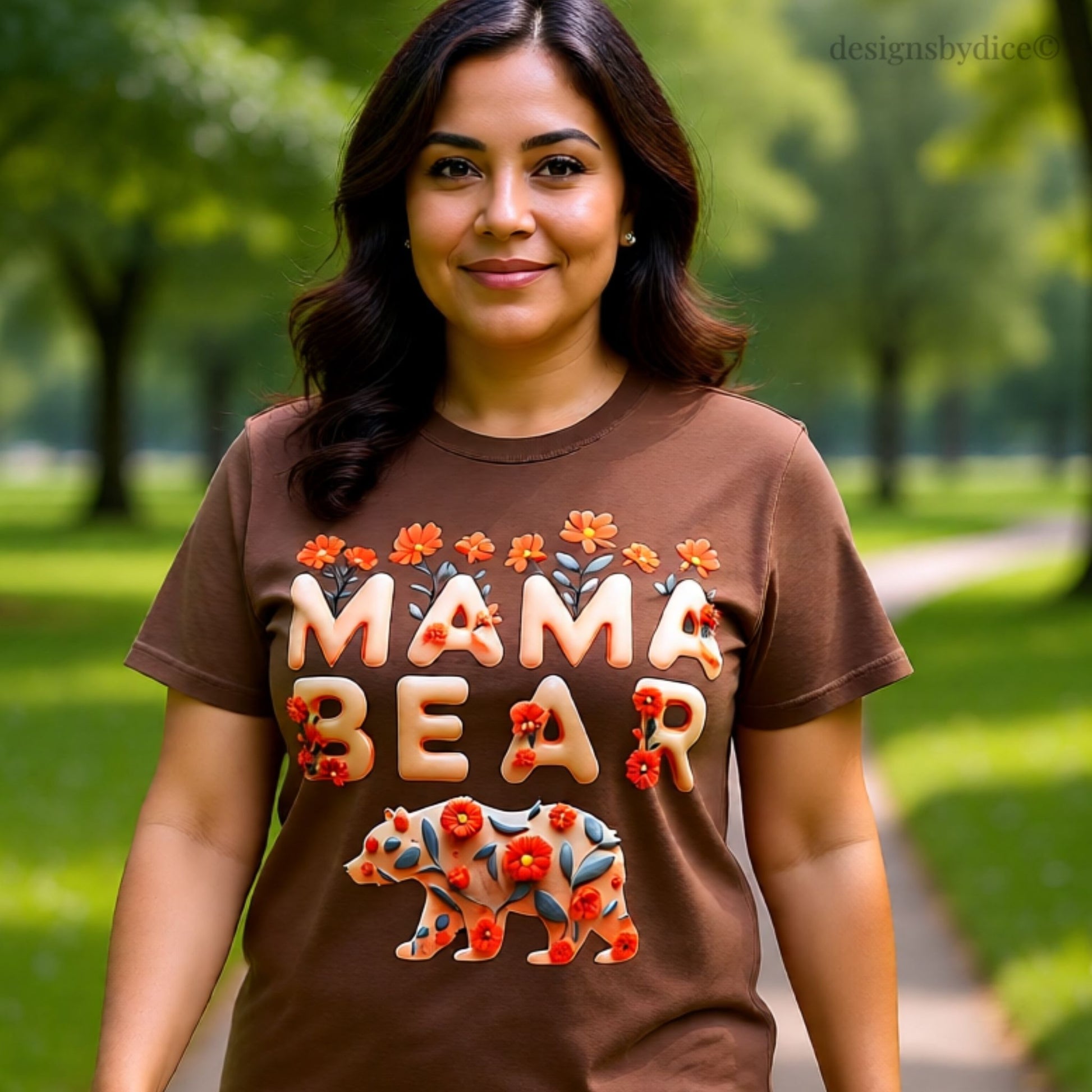 Woman wearing a brown 'Mama Bear' t-shirt in a park setting