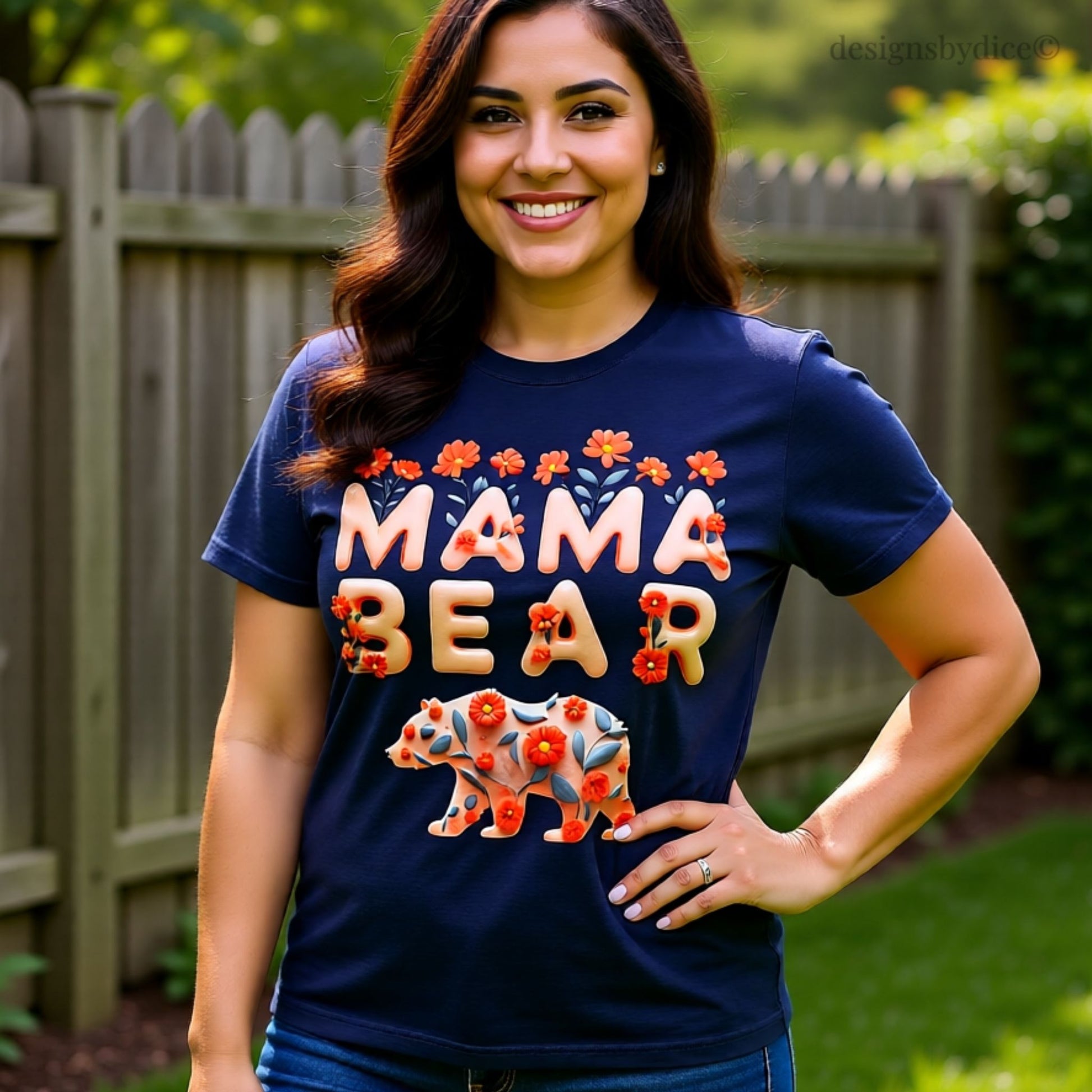 Woman wearing a navy blue 'Mama Bear' t-shirt with floral designs outdoors.