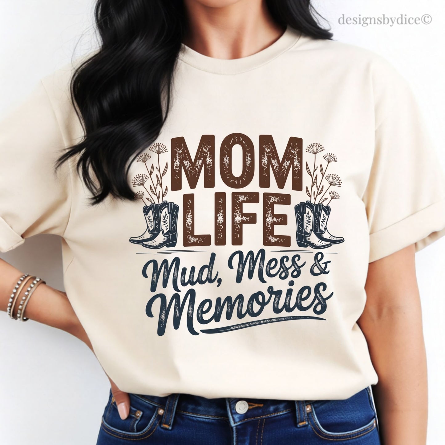 Person wearing a cream-colored t-shirt with 'Mom Life: Mud, Mess & Memories' text and graphic.