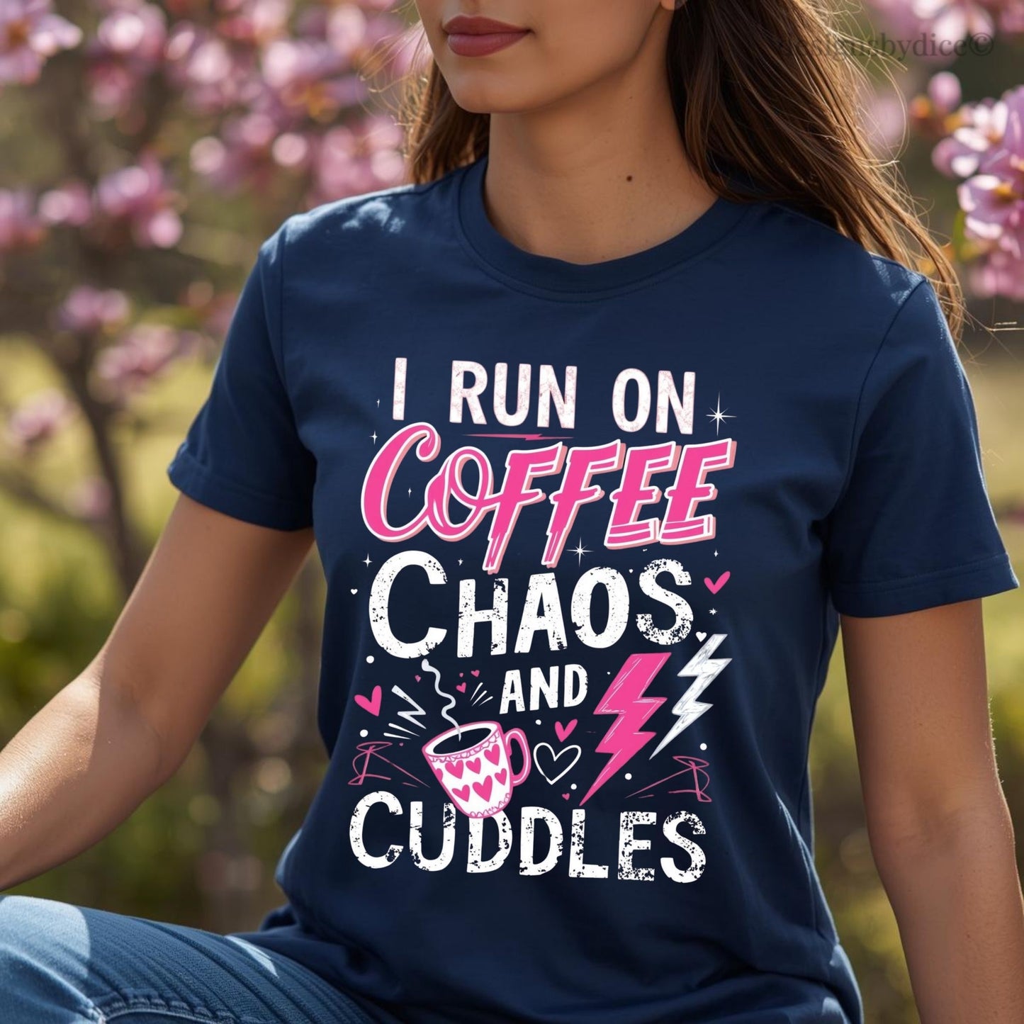 Person wearing a navy blue t-shirt with text 'I run on coffee, chaos, and cuddles' in an outdoor setting.