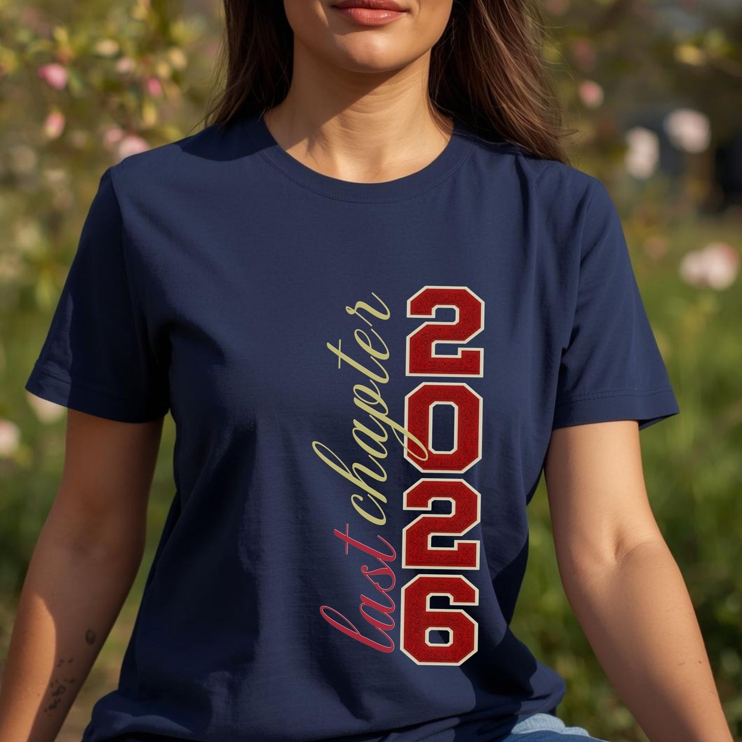 Person wearing a navy blue t-shirt with '2026 last chapter' text in red and gold.