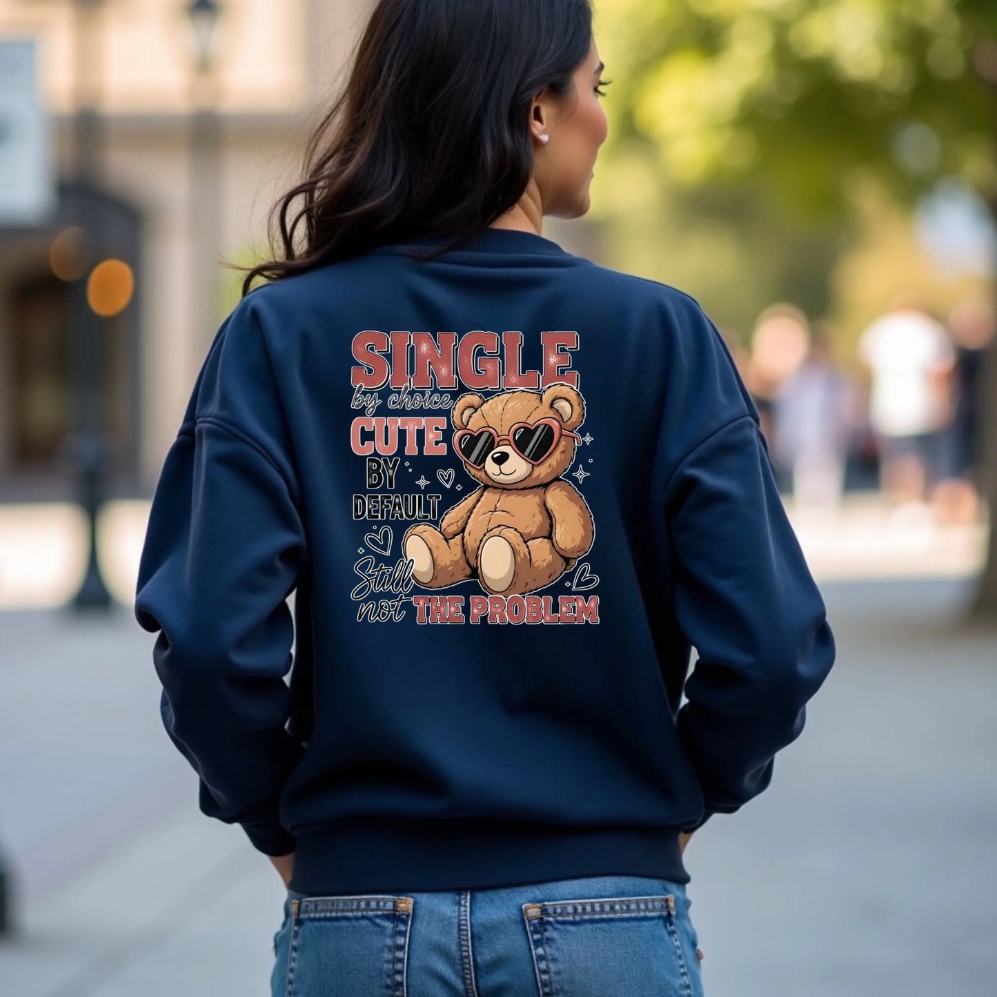 Person wearing a navy blue sweatshirt with a teddy bear graphic and text on the back.