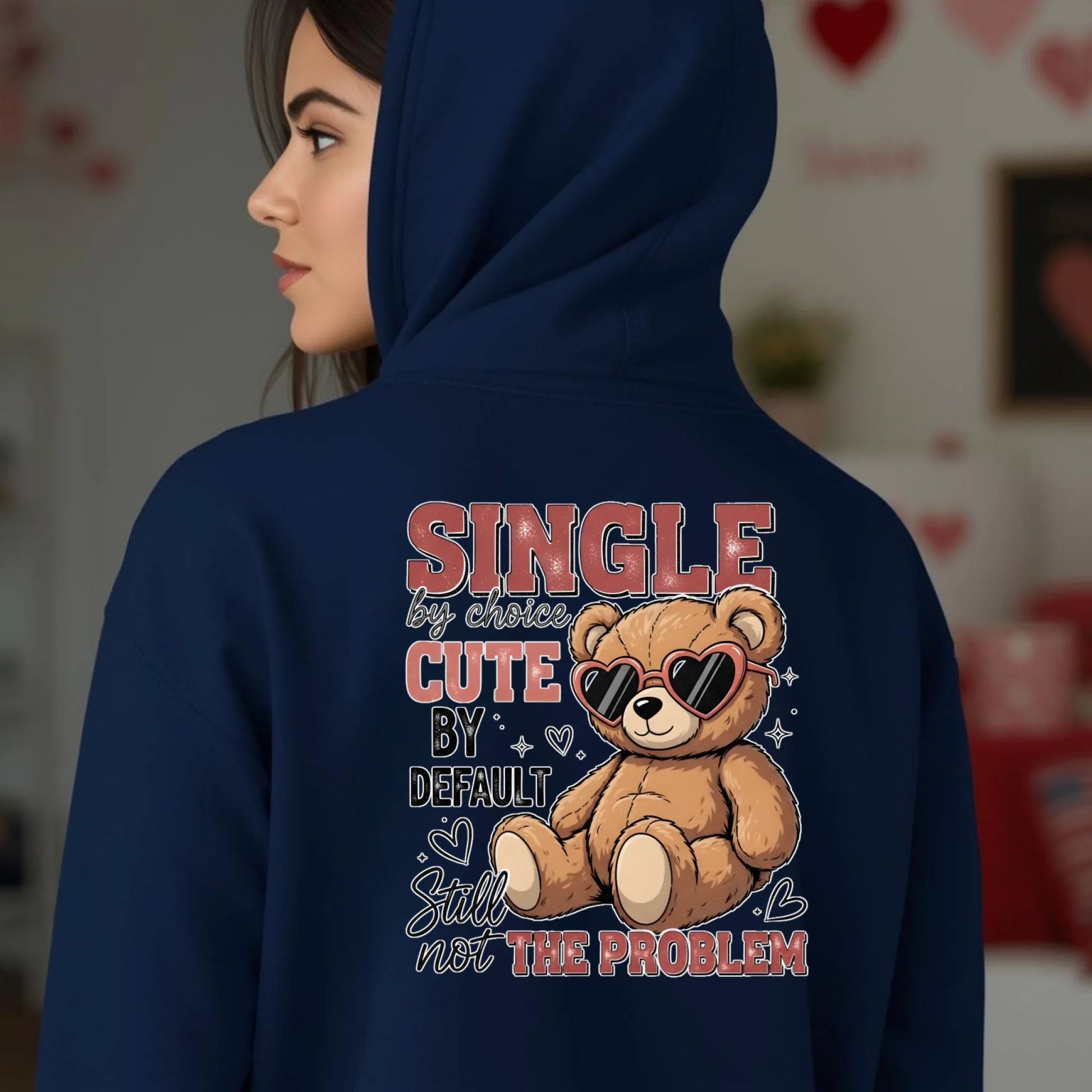 Navy blue hoodie with a teddy bear graphic and text on the back, worn by a person.