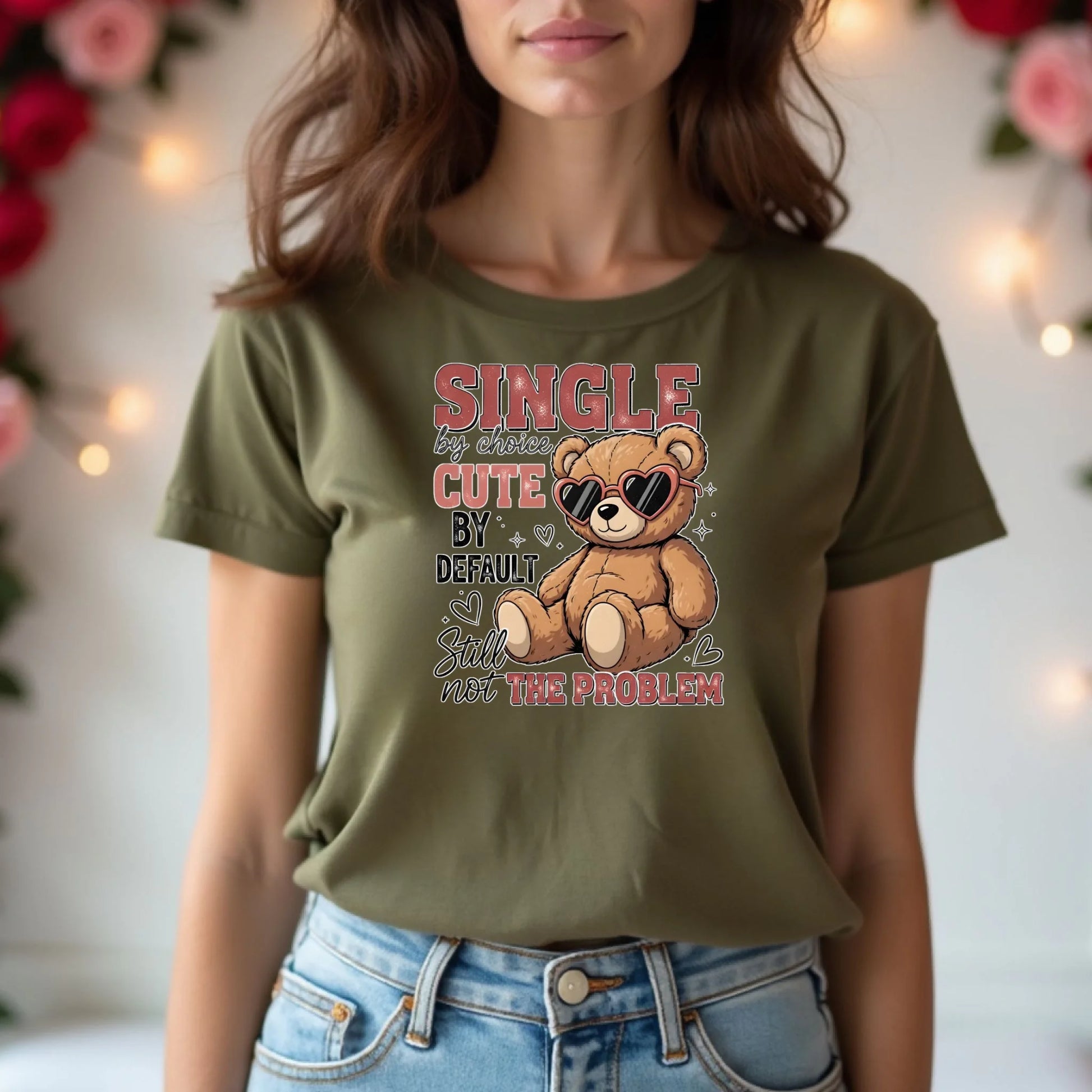 Person wearing a green t-shirt with a teddy bear graphic and text.