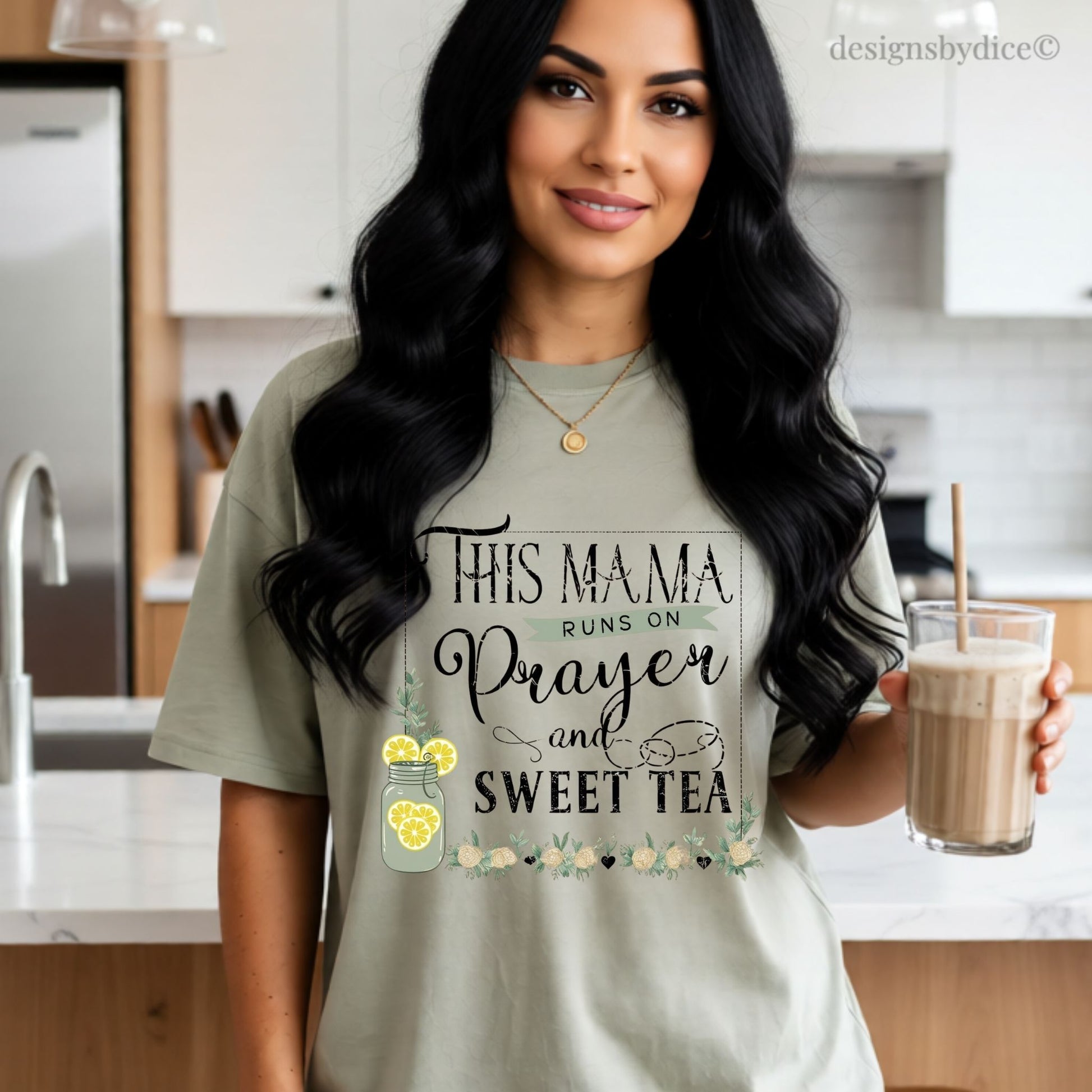Woman wearing a khaki colored t-shirt "this mama runs on prayer and sweet tea" quote about in a kitchen.