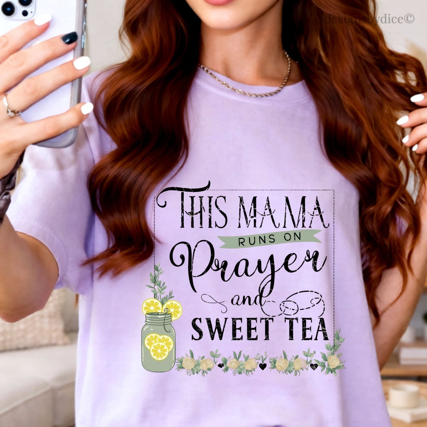 Woman wearing a orchid t-shirt with text 'This mama runs on prayer and sweet tea' and lemon graphics.