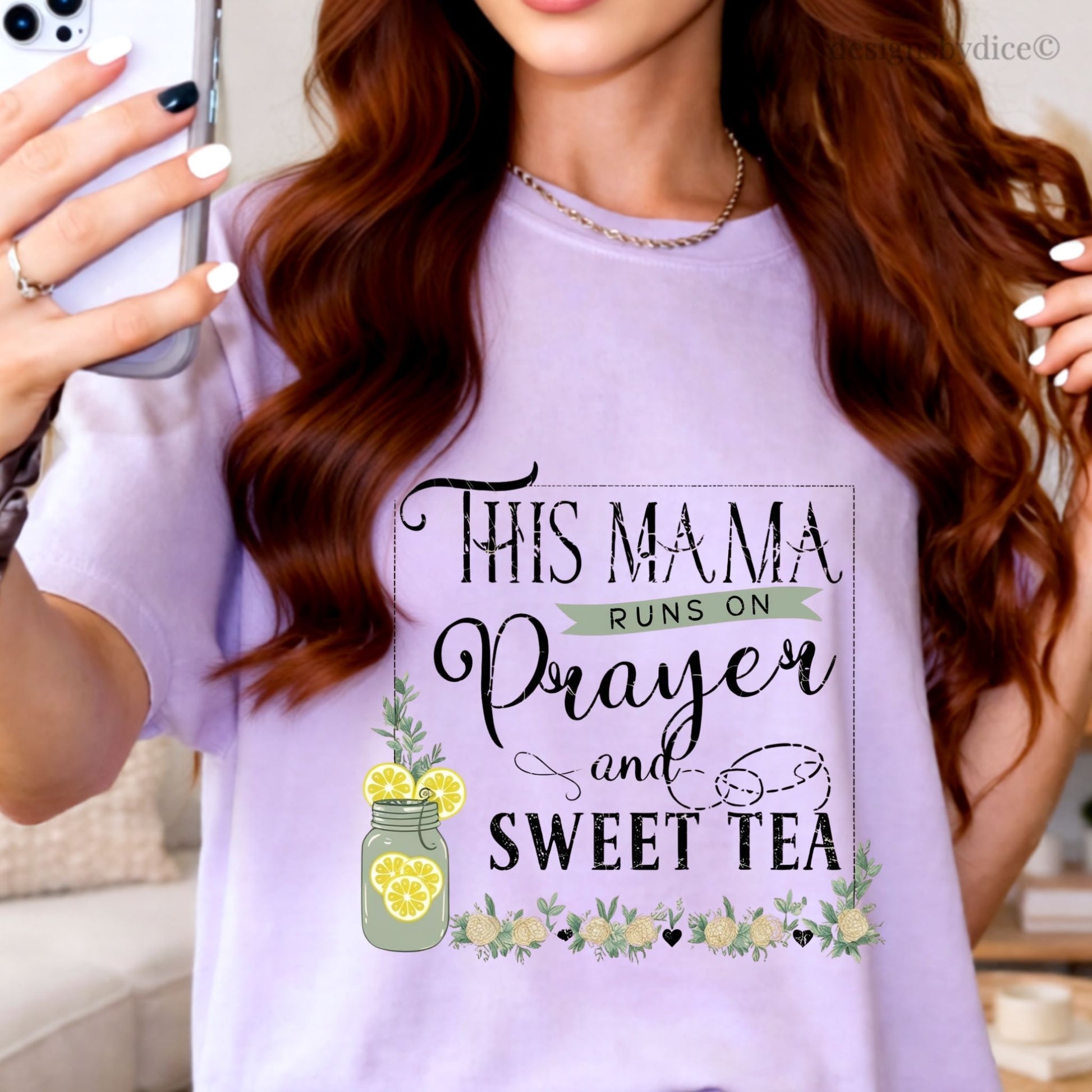Woman wearing a orchid t-shirt with text 'This mama runs on prayer and sweet tea' and lemon graphics.