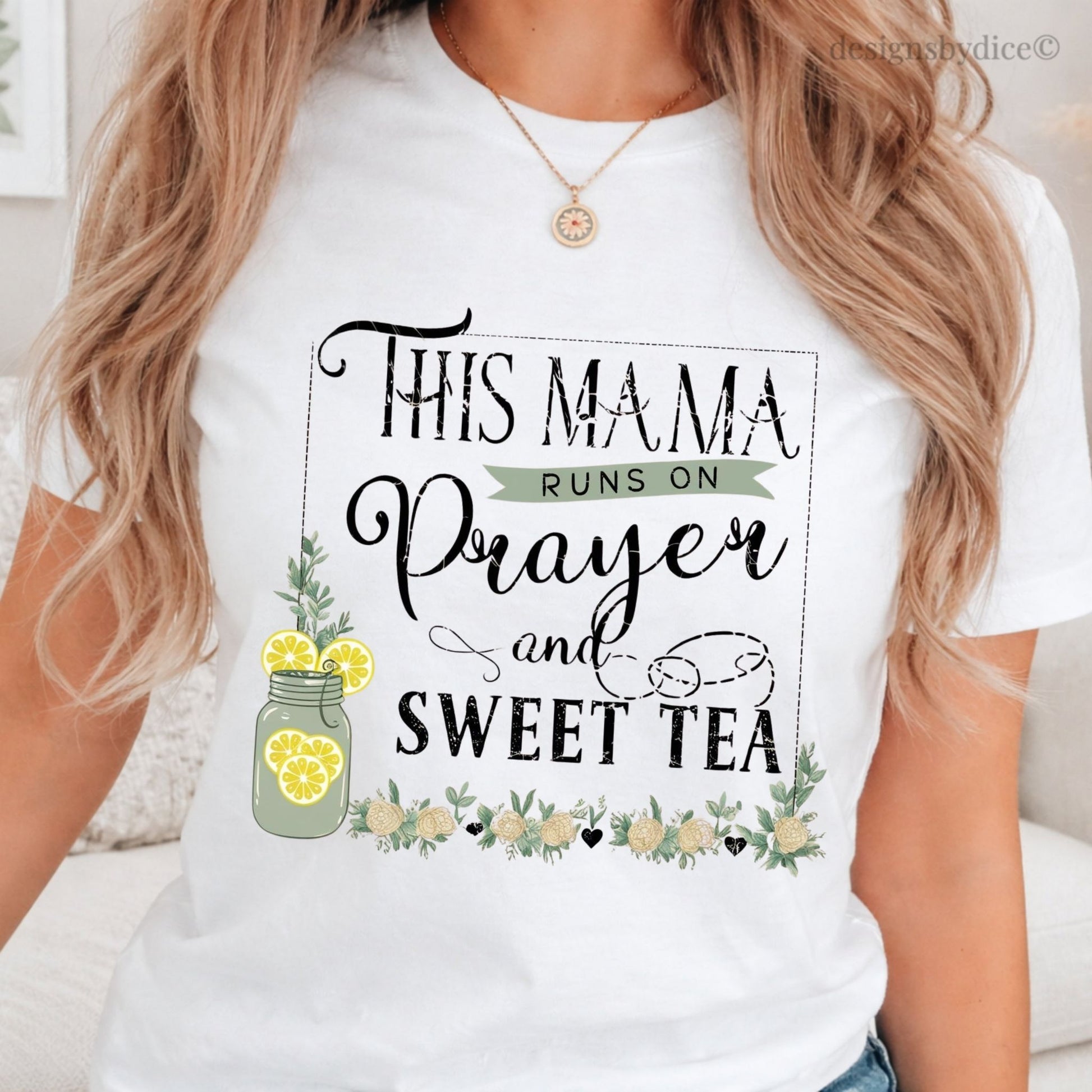 White t-shirt with 'This Mama Runs on Prayer and Sweet Tea' design worn by a person.