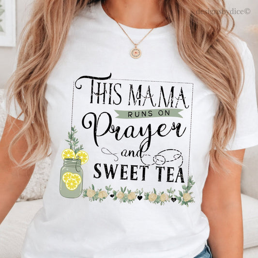 White t-shirt with 'This Mama Runs on Prayer and Sweet Tea' design worn by a person.