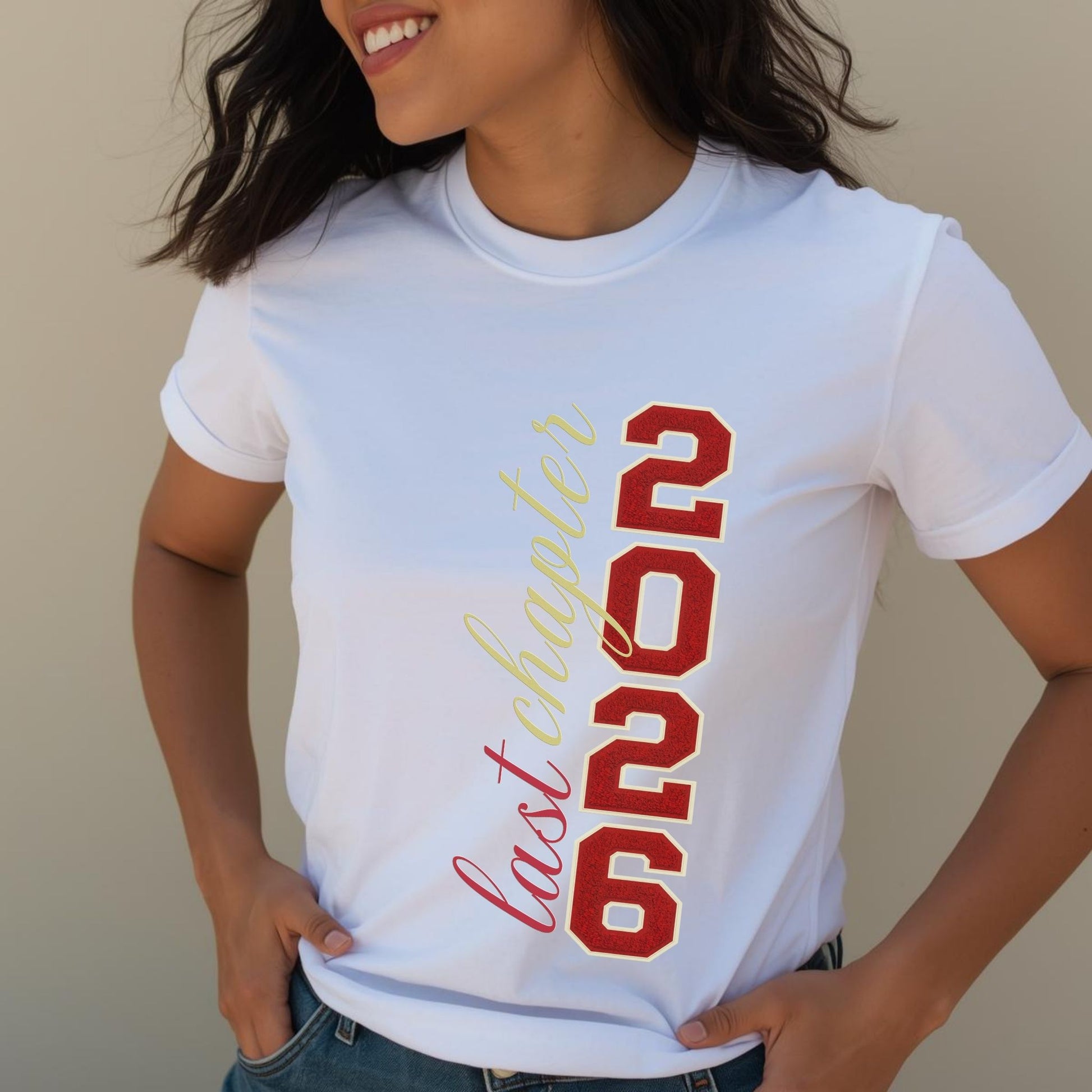 Person wearing a white t-shirt with red and gold text on a beige background