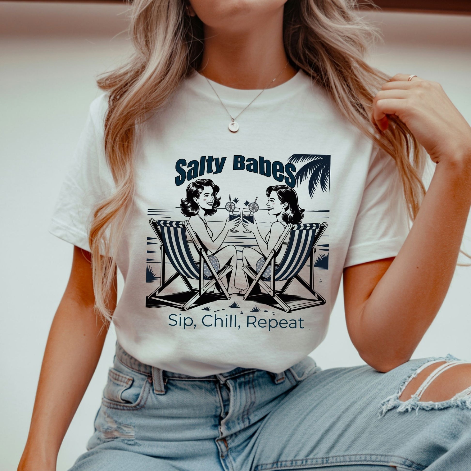 Person wearing a white t-shirt with 'Salty Babes' graphic and text.